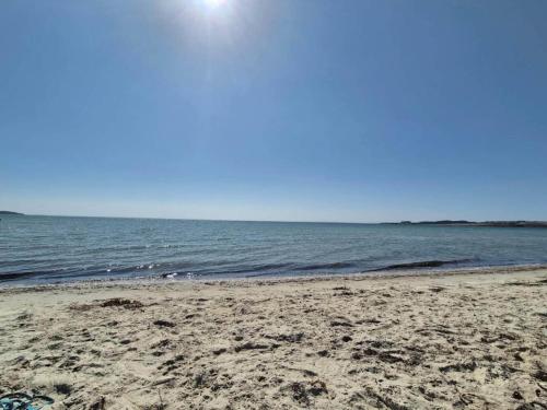 a sandy beach with the ocean in the background at 8 person holiday home in Knebel-By Traum in Knebel