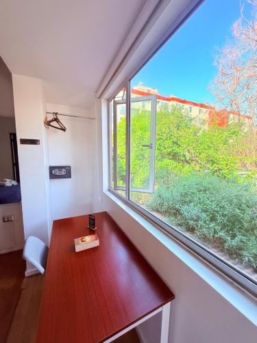 a room with a wooden bench and a window at MAKTVB Europa - Hostal Boutique in Santiago