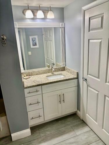 a bathroom with a sink and a mirror at Ocean Walk Resort - Spectacular Ocean Front View in Daytona Beach