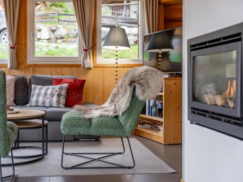 a living room with a dog sitting on a chair at Die Bergliebe in Hohentauern