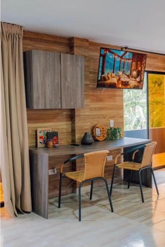 a dining room with a table and two chairs at Cabañas con jacuzzi y chimenea - Casa Floral, Marinilla in Marinilla