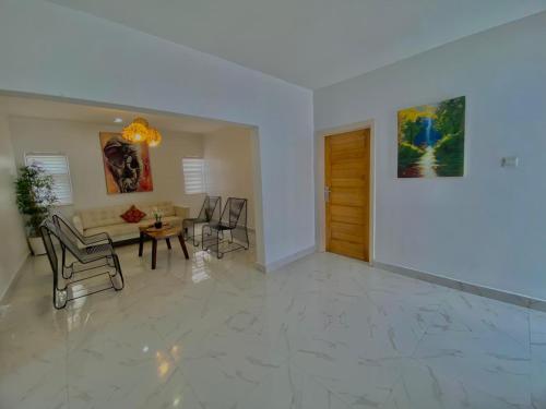 a living room with a couch and a table at Luxury Urban Villa 3V in Kumasi