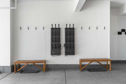 two benches sitting in front of a white wall at Jordanelle Express Gondola Condo 3 BR Hot Tub in Cranmer