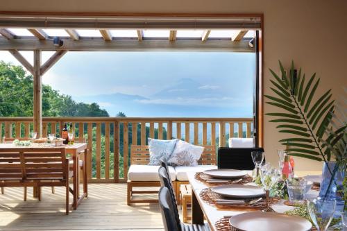 a patio with a table and chairs on a deck at Vista Fuji Retreat in Kannami