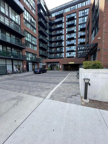 a parking lot in front of a large building at Vibrant 1 Bedroom Condo Apt in Toronto