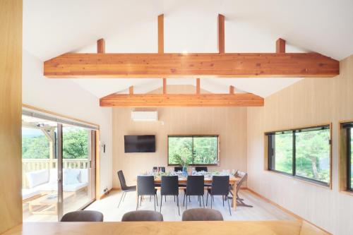 a dining room with a table and chairs at Vista Fuji Retreat in Kannami