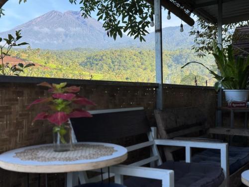 a table and chairs with a view of a mountain at Laa Cabana Lombok Glamping in Sapit