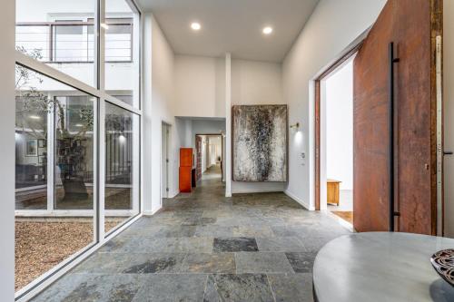 an empty hallway with a table and large windows at Herdade Vale Castelo in Reguengos de Monsaraz