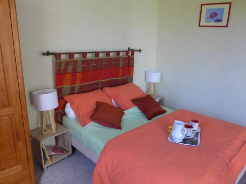 a bedroom with a bed with a red blanket and two lamps at Maison sur la Marne avec terrasse, 2 chambres - FR-1-611A-2 in Soncourt-sur-Marne