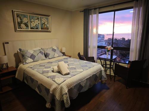 a bedroom with a bed and a large window at Hotel 251 in Viña del Mar