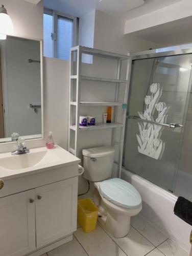 a bathroom with a shower and a toilet and a sink at Exclusive Offer - A special deal ending soon!! Super Nice Location - Very close to YVR Airport and shopping center & easy transportation in Vancouver