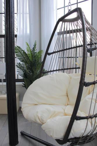 a swing chair in a living room with a white couch at Beautiful 2 BED 2 BATH Soaker Tub in Albany