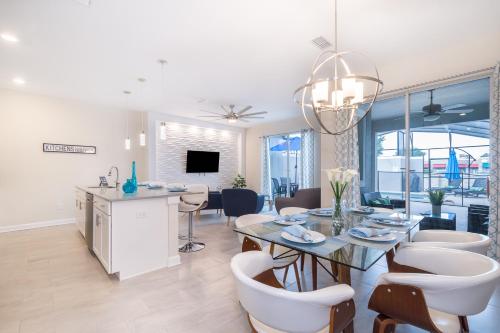 a dining room and living room with a table and chairs at Stunning Townhouses 5 Minutes away Disney! in Kissimmee