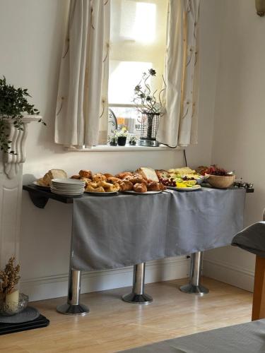 a table with a bunch of bread and other food on it at Sonas house in Kilkenny
