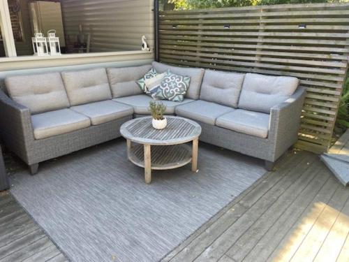 a patio with a couch and a table at 4 star holiday home in SÖLVESBORG in Falkvik