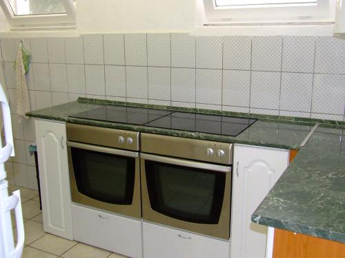 a kitchen with a stove and a counter top at Relax Apartmans in Balatonszemes