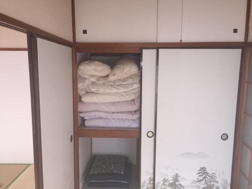 a closet with a stack of folded towels at D-pdal Inn - Vacation STAY 38493v in Tokyo