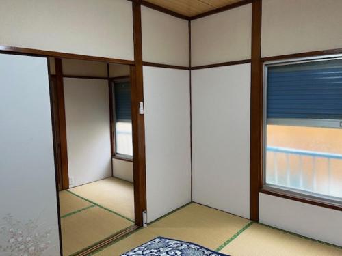 a room with two windows and a mirror at D-pdal Inn - Vacation STAY 38493v in Tokyo