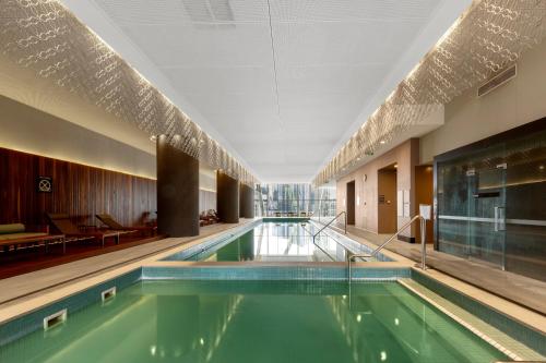 a swimming pool in a hotel room with a pool at Astra Apartments Southbank Prima Pearl in Melbourne