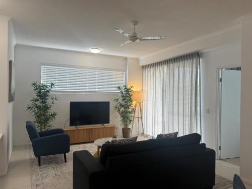 a living room with a couch and a television at Boulevard North Lakes in North Lakes