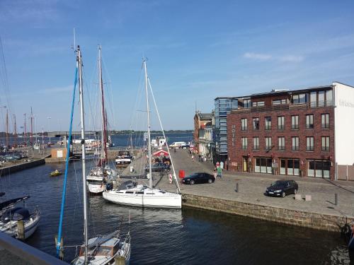 a group of boats are docked in a harbor at Hochwertige Apartments im Stralsunder Hafen in Stralsund