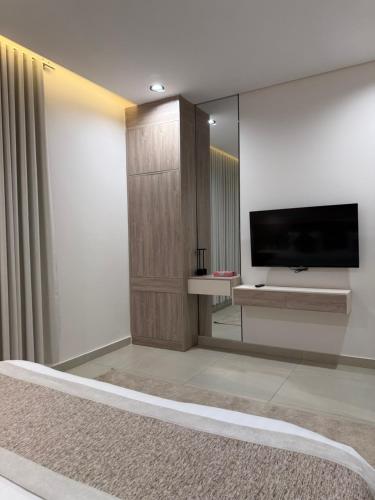 a living room with a flat screen tv on a wall at شفق in Al Shafa