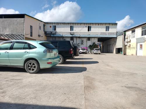 a blue car parked in a parking lot at GBC Hotel in Dili