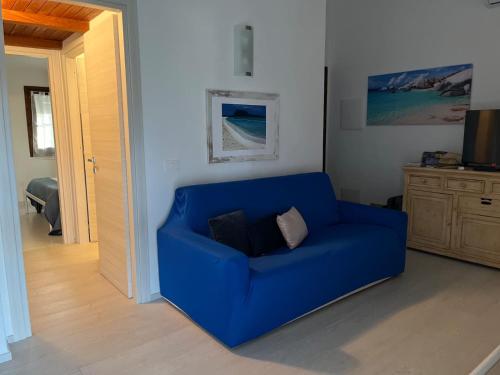 a blue couch sitting in a living room at San Teodoro Beach Villa 86b in San Teodoro