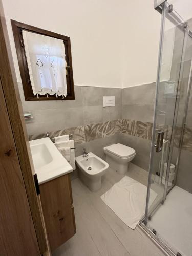 a bathroom with a toilet and a sink and a shower at San Teodoro Beach Villa 86b in San Teodoro