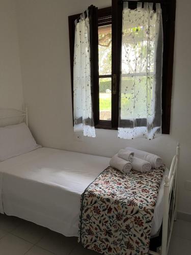 a bedroom with two beds and a window at San Teodoro Beach Villa 86b in San Teodoro