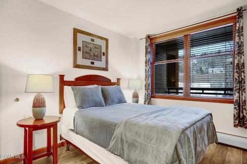 a bedroom with a bed and a window at Ski-In Ski-Out Zephyr 1 Bedroom Condo 2204 in Winter Park