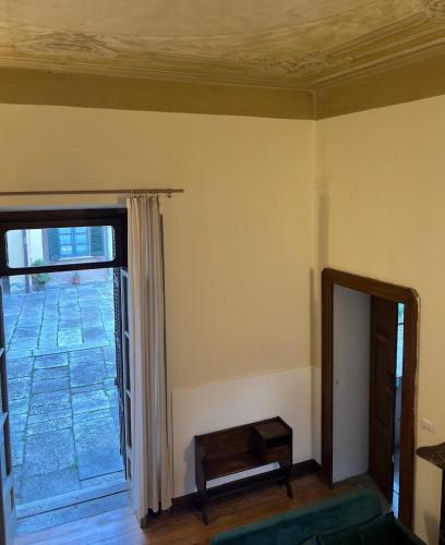 a living room with a window and a mirror at Peonia Riviera d'Orta in Gozzano