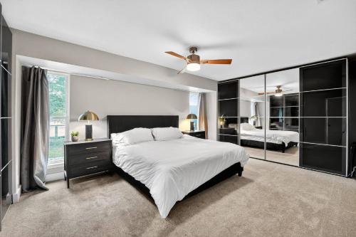 a bedroom with a large bed and a ceiling fan at Stylish 3BR Home + Private Pool in Austin