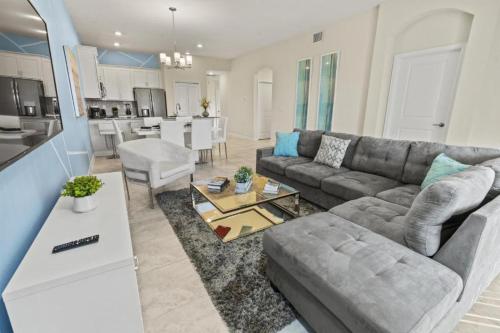 a living room with a couch and a table at Lovely apartments 18 Minutes away from Disney! in Kissimmee