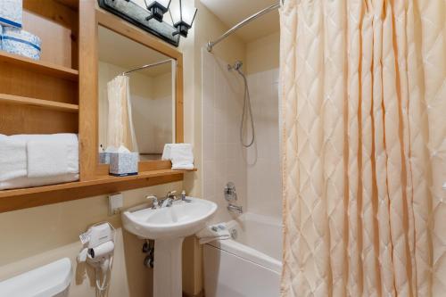 a bathroom with a sink and a shower curtain at Expedition Station 8574 by Summit County Mountain Retreats in Snake River Health Services Incorporated Heliport