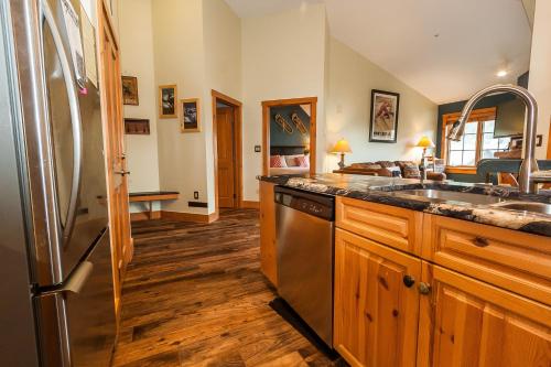 a kitchen with a sink and a refrigerator at Expedition Station 8633 by Summit County Mountain Retreats in Snake River Health Services Incorporated Heliport