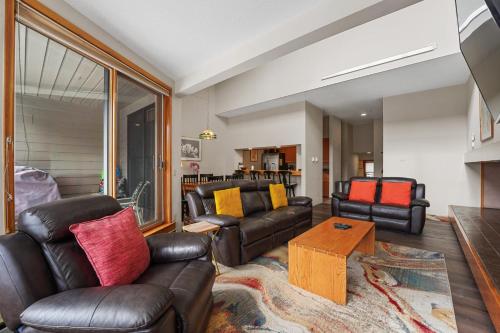 a living room with leather furniture and a table at Quicksilver 1658 by Summit County Mountain Retreats in Keystone