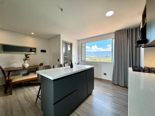 a kitchen and dining room with a large window at Torre Zurich Luxury in Medellín