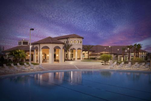 a large swimming pool in front of a building at Lovely apartments 18 Minutes away from Disney! in Kissimmee
