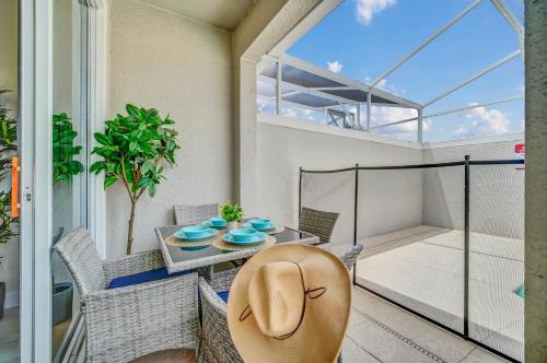 a patio with a table and chairs on a balcony at Lovely apartments 18 Minutes away from Disney! in Kissimmee