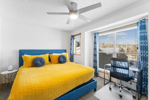 a bedroom with a yellow bed and a chair and a window at Saddle Ridge Townhomes 253 by Summit County Mountain Retreats in Sentinel Island