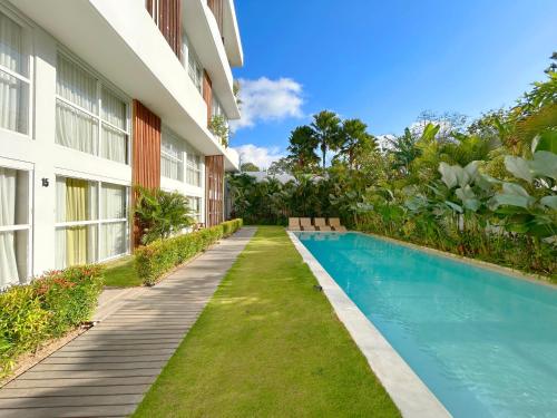 Vista exterior de un edificio con piscina. en Tropicana Bingin Managed by CPM Bali, en Uluwatu