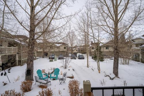 a yard covered in snow with two chairs and tables at Prospect Point Townhomes 202C by Summit County Mountain Retreats in Summit Medical Center Heliport
