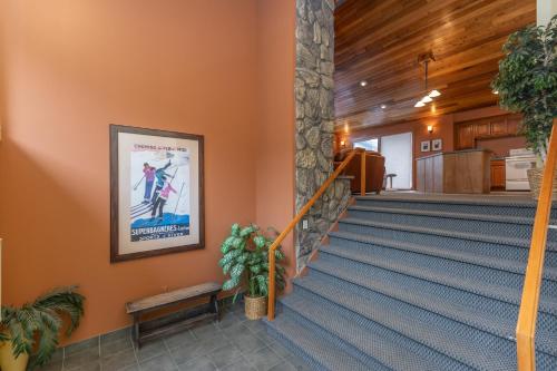 a staircase in a building with a poster on the wall at Lake Cliffe 307 Building A by Summit County Mountain Retreats in Dillon