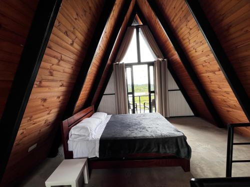 a bedroom with a bed in a room with a window at Cabaña Finca La Manuela1 in Garzón