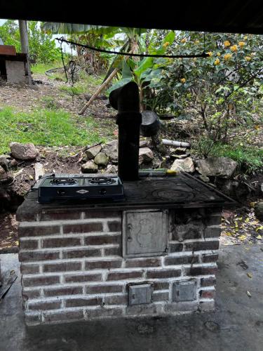 a brick oven with a stove on top of it at Cabaña Finca La Manuela1 in Garzón