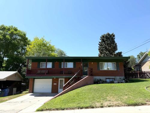 a red brick house with a garage at Park Home- Parkside Haven for Families & Pets in Pocatello