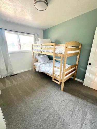 a bedroom with two bunk beds in a room at Park Home- Parkside Haven for Families & Pets in Pocatello