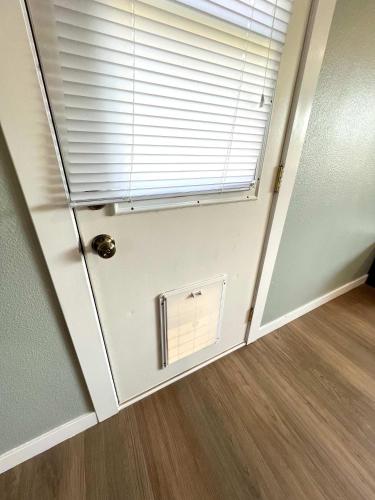 a room with a window and a door with a blind at Park Home- Parkside Haven for Families & Pets in Pocatello