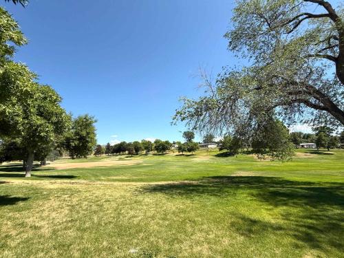 a field of grass with trees and a golf course at Park Home- Parkside Haven for Families & Pets in Pocatello